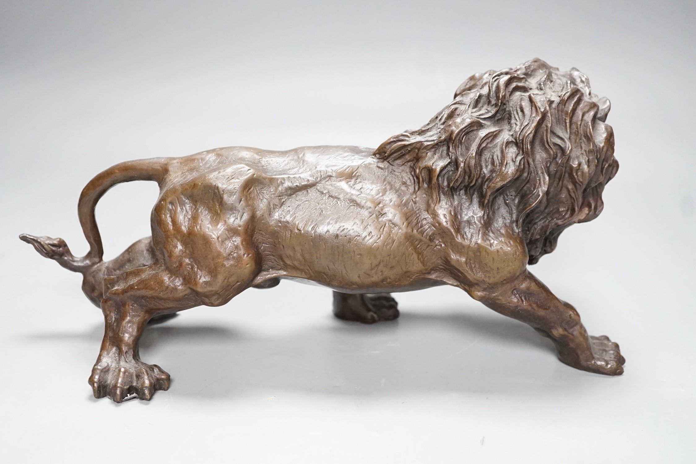 A 20th century bronze figure of a lion, 30cm long